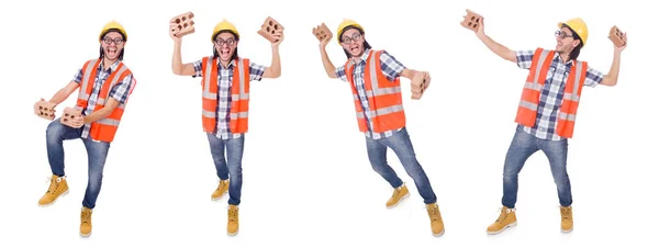 Lustige junge Bauarbeiter mit gebrochenem Ziegelstein isoliert auf wh — Stockfoto