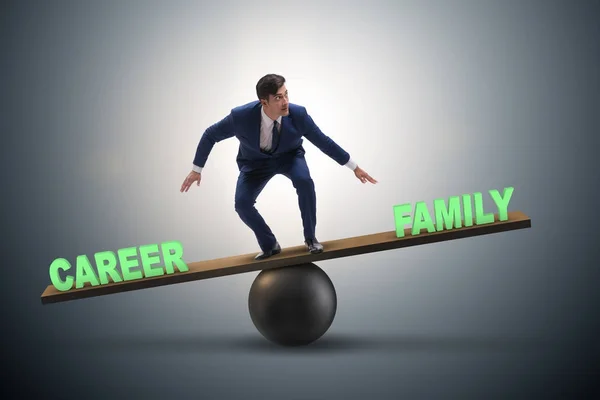 Businessman balancing between career and family in business conc — Stock Photo, Image