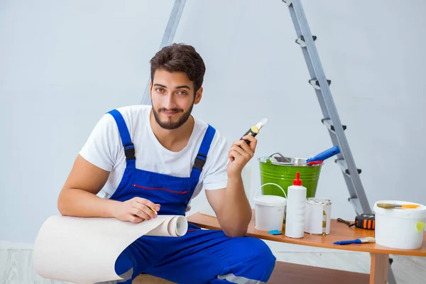 Reparateur bei Renovierungsarbeiten im Haus mit Papiertapete — Stockfoto