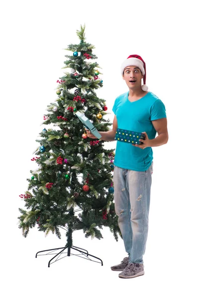 Young man decorating christmas tree isolated on white — Stock Photo, Image