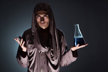 Alchemist doing experiments in alchemy concept clipart