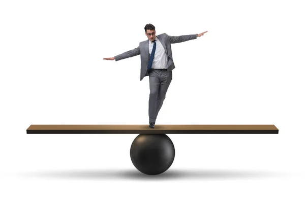 Businessman balancing on seesaw in uncertainty concept — Stock Photo, Image