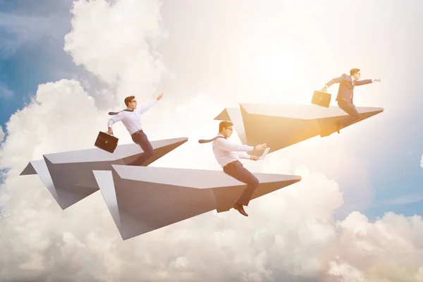 Businessman flying on paper plane in business concept