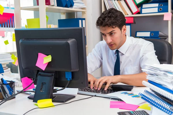 Businessman working in the office with piles of books and papers — Stock Photo, Image