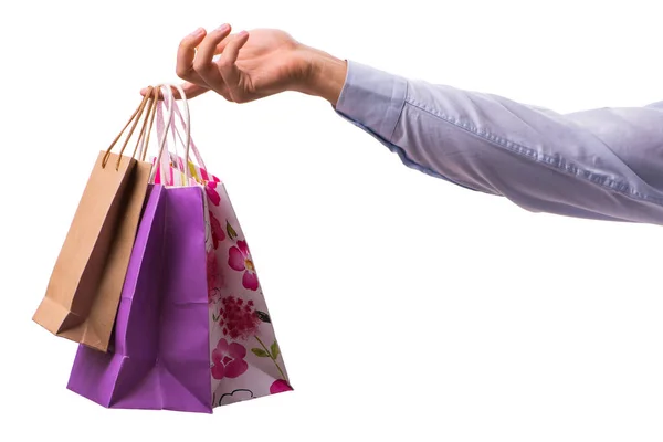 Ręczne trzymanie torby na zakupy ze świątecznymi zakupami na białym grzbiecie — Zdjęcie stockowe