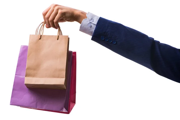 Mano sosteniendo bolsas de compras con compras de Navidad en la espalda blanca — Foto de Stock