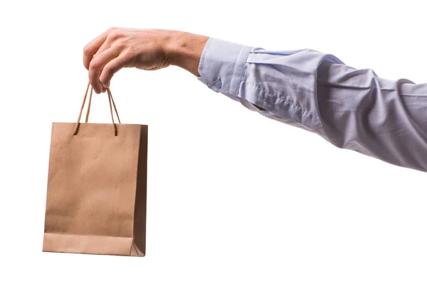 Hand holding shopping bags with christmas shopping on white back — Stock Photo, Image