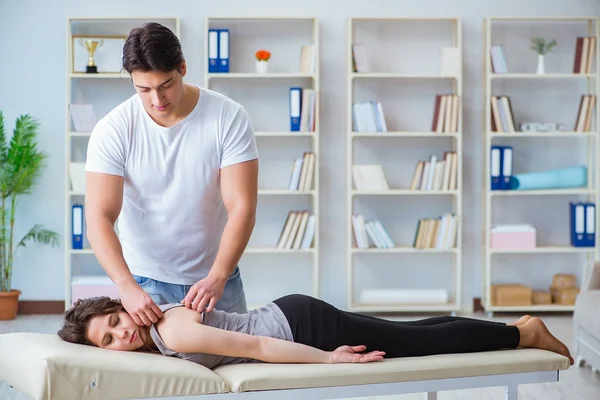 Young doctor chiropractor massaging female patient woman — Stock Photo, Image