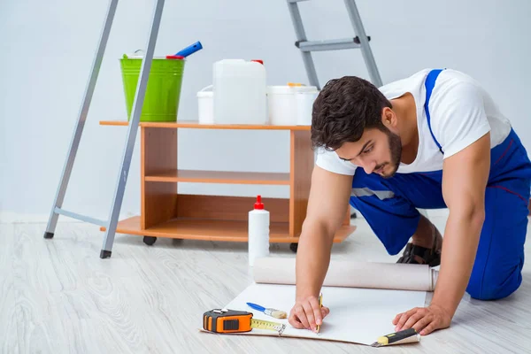 Szerelő csinál felújítás javítás a házban a papír tapéta — Stock Fotó