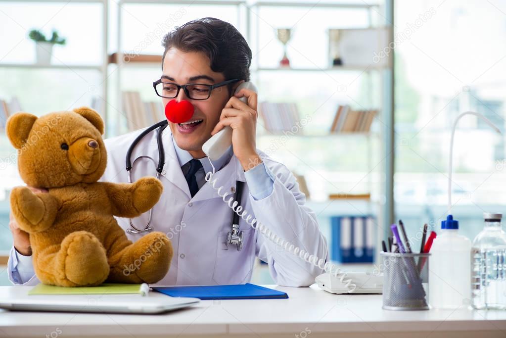 Funny pediatrician with toy in the hospital clinic