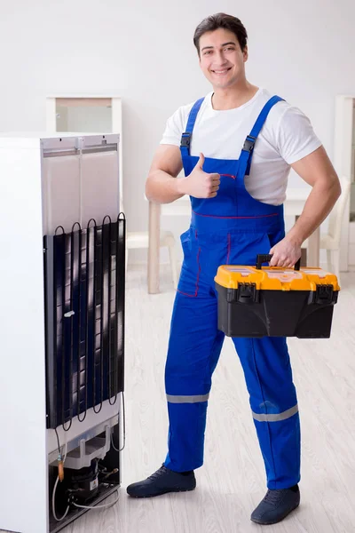 Repairman contractor repairing fridge in DIY concept