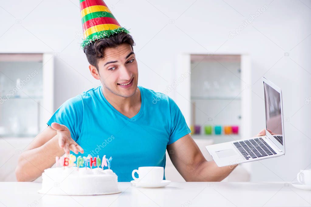 Young man celebrating birthday alone at home