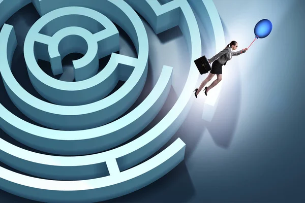 Businesswoman escaping from maze on balloon — Stock Photo, Image