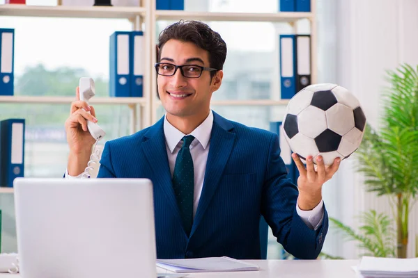 Businessman playing football in the office — Stock Photo, Image