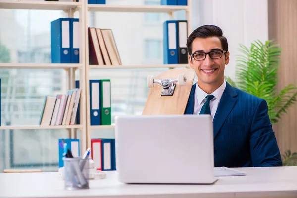 Uomo d'affari con skateboard in ufficio — Foto Stock