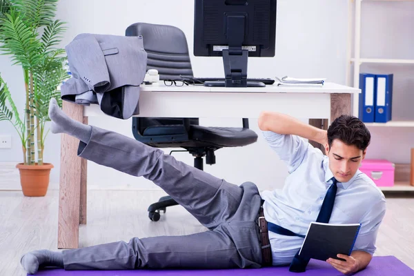 Businessman doing sports in office during break — Stock Photo, Image