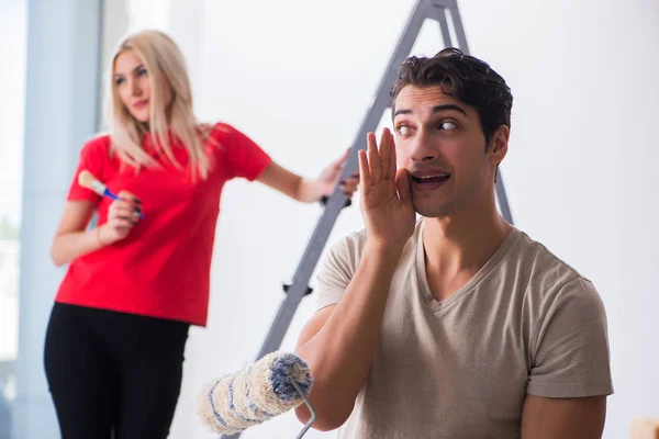 Young family doing painting job during home renovation