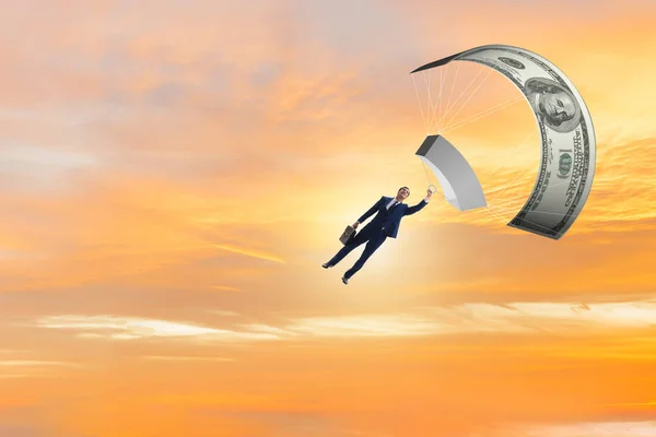 Businessman in golden parachute concept