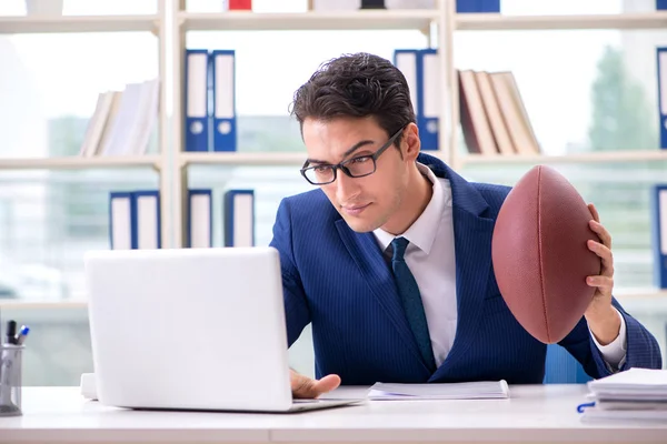 Empresario con fútbol americano en la oficina — Foto de Stock