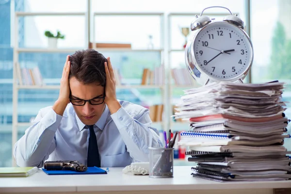 Angry businessman with gun thinking of committing suicide