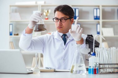 Genç araştırmacı bilim adamı bir su testi kirliliği araştırması yapıyor.