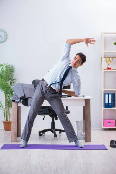 Businessman doing sports in office during break — Stock Photo, Image