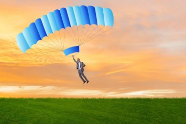 Genç işadamı iş konseptinde paraşütle atlıyor