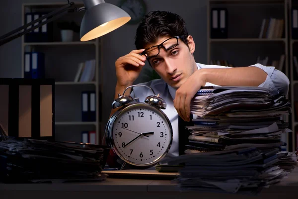 Young businessman working overtime late in office