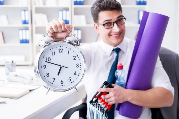 Businessman rushing to sports with clock — Stock Photo, Image