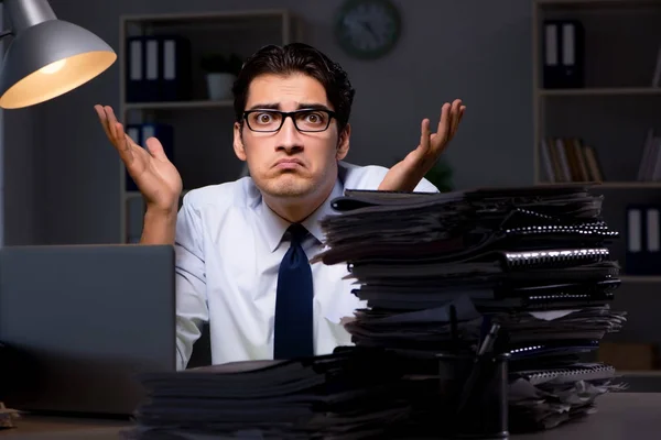 Young businessman working overtime late in office