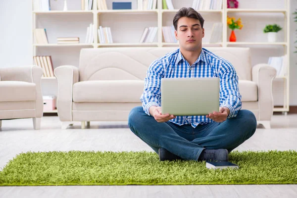 Young handsome man sitting on floor at home — Stock Photo, Image