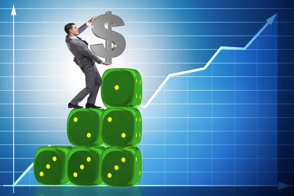 Businessman holding dollar sign on top of dice pyramid — Stock Photo, Image