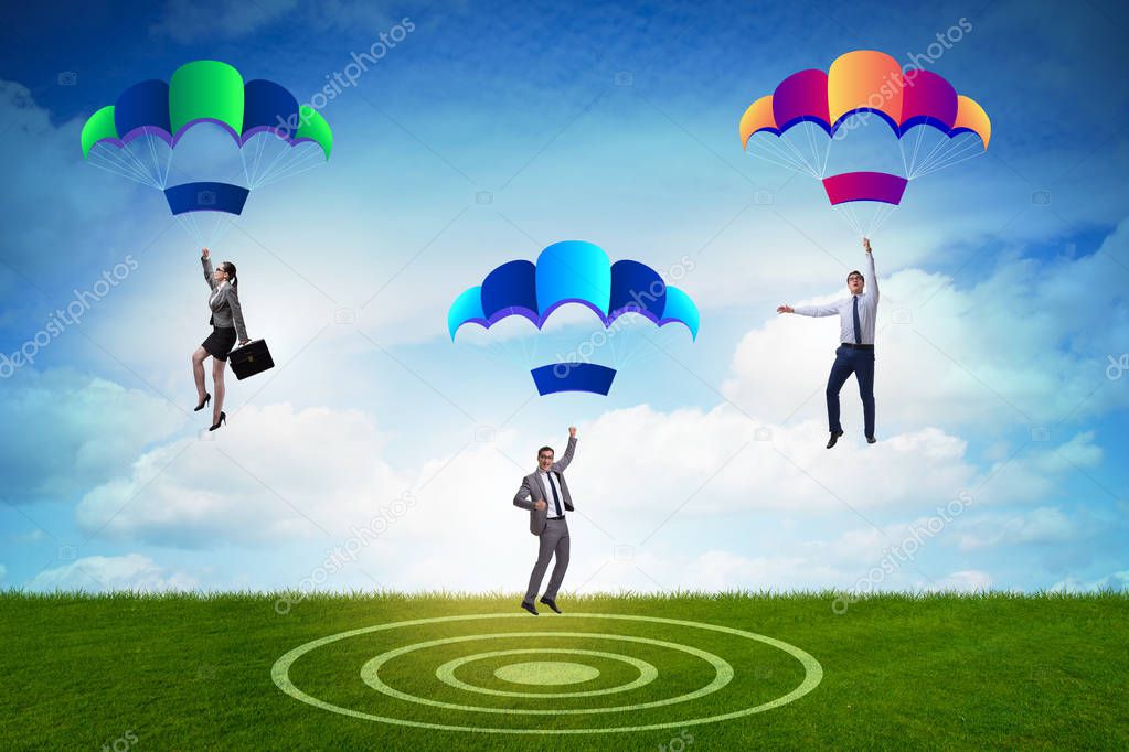 Business people falling down on parachutes