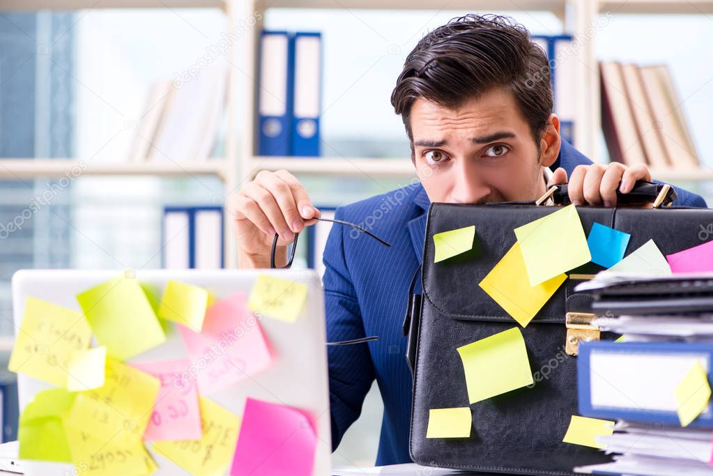 Businessman with reminder notes in multitasking concept