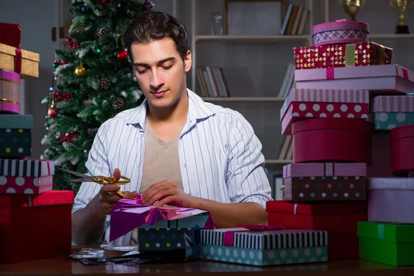 Man with many christmas gifts in boxes — Stock Photo, Image