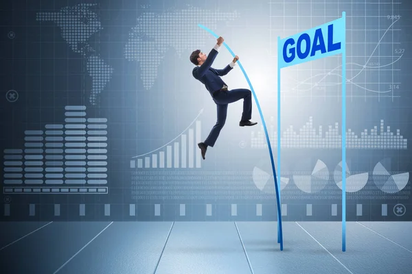 Businessman pole vaulting towards his goal in business concept — Stock Photo, Image