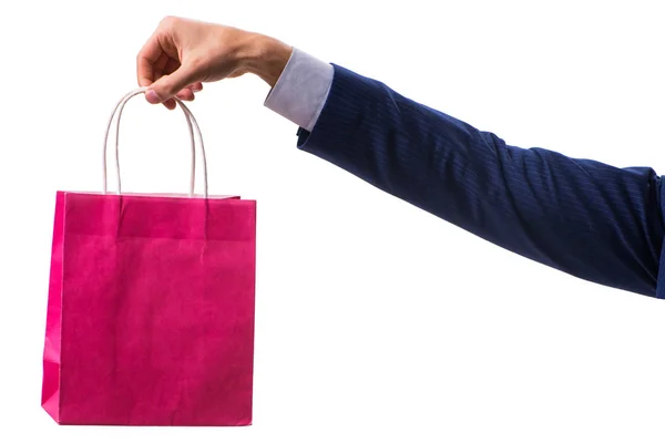 Ręczne trzymanie torby na zakupy ze świątecznymi zakupami na białym grzbiecie — Zdjęcie stockowe