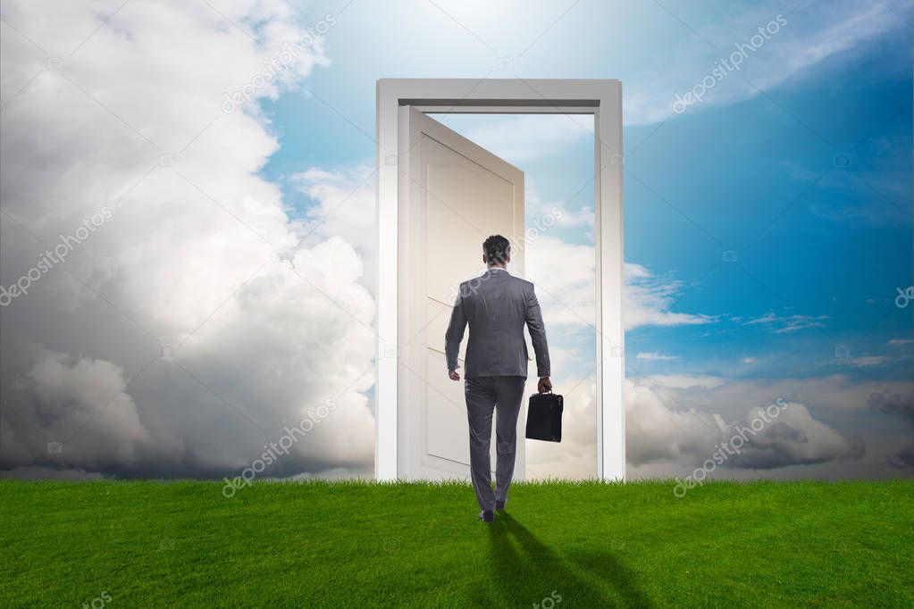 Businessman standing in front of door into future