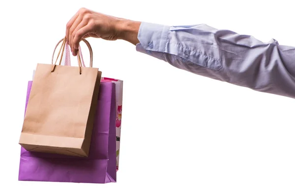 Mano sosteniendo bolsas de compras con compras de Navidad en la espalda blanca — Foto de Stock