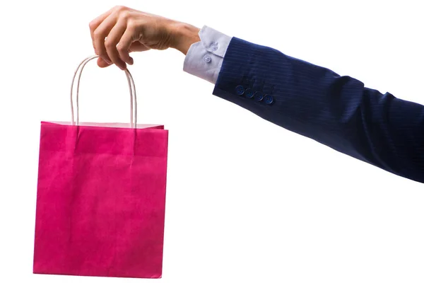 Mano sosteniendo bolsas de compras con compras de Navidad en la espalda blanca —  Fotos de Stock