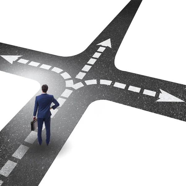 Young businessman at crossroads in uncertainty concept — Stock Photo, Image