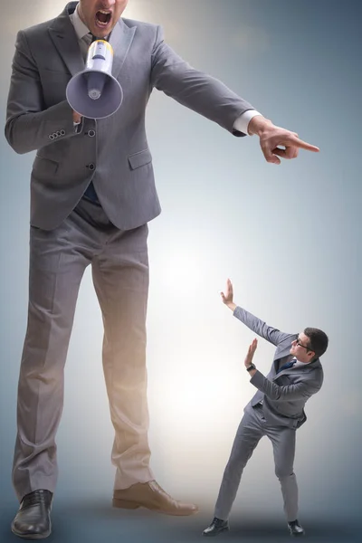 Bad angry boss shouting at employee with loudspeaker — Stock Photo, Image