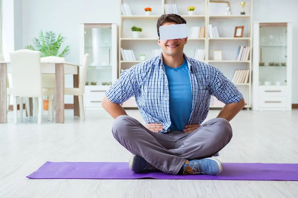 Man wearing virtual reality VR glasses doing sports at home