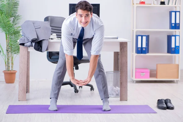 Businessman doing sports in office during break — Stock Photo, Image