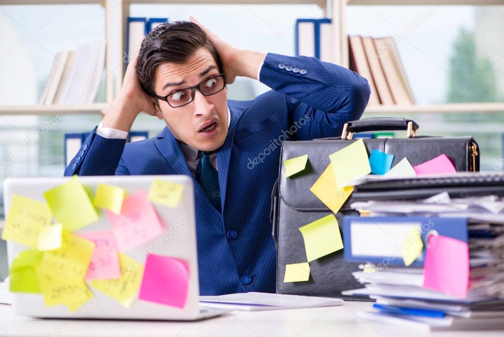 Businessman with reminder notes in multitasking concept