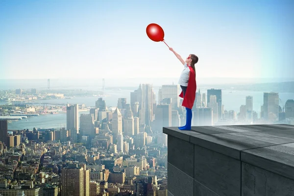 Young girl in superhero costume overlooking the city — Stock Photo, Image