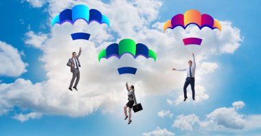 İş adamları paraşütlerin üzerine düşüyor.