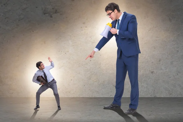 Bad angry boss shouting at employee with loudspeaker — Stock Photo, Image