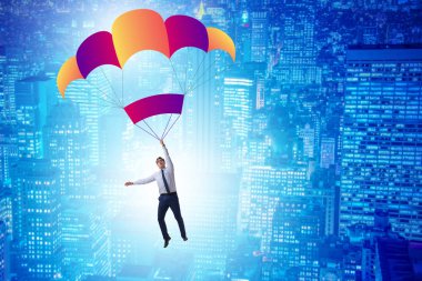 Genç işadamı iş konseptinde paraşütle atlıyor