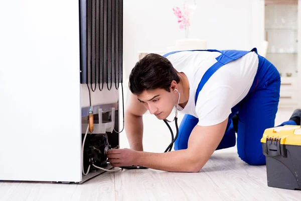 Repairman contractor repairing fridge in DIY concept — Stock Photo, Image